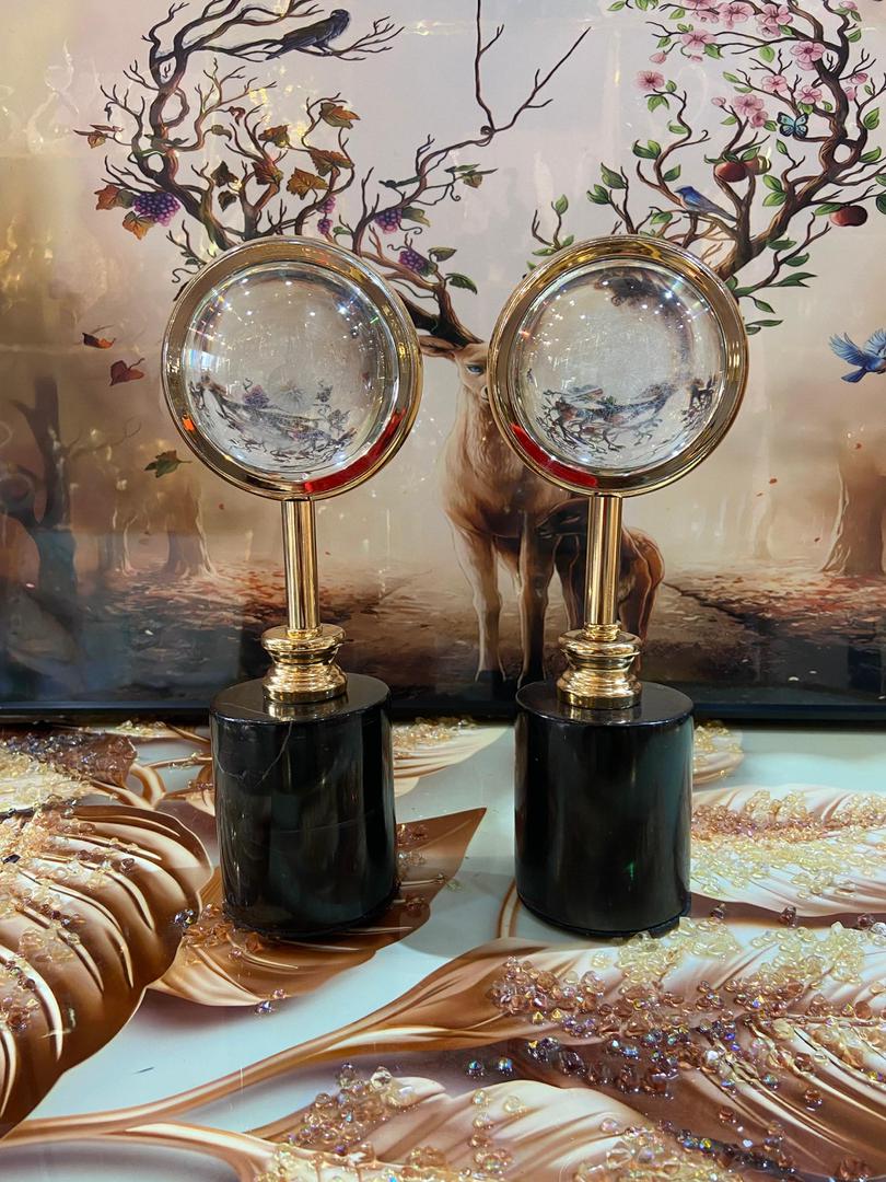 Crystal globe ornaments on marble pedestals